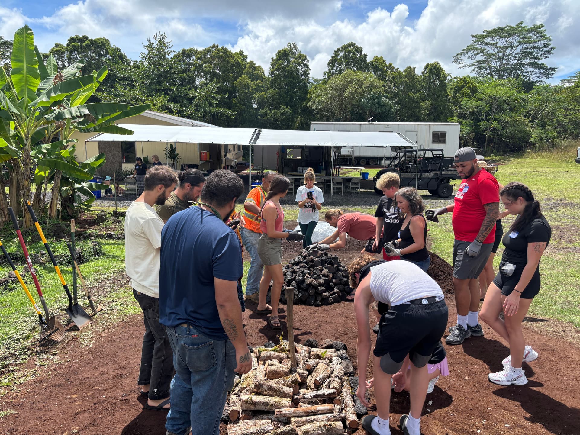 People building an underground oven in hawaii.