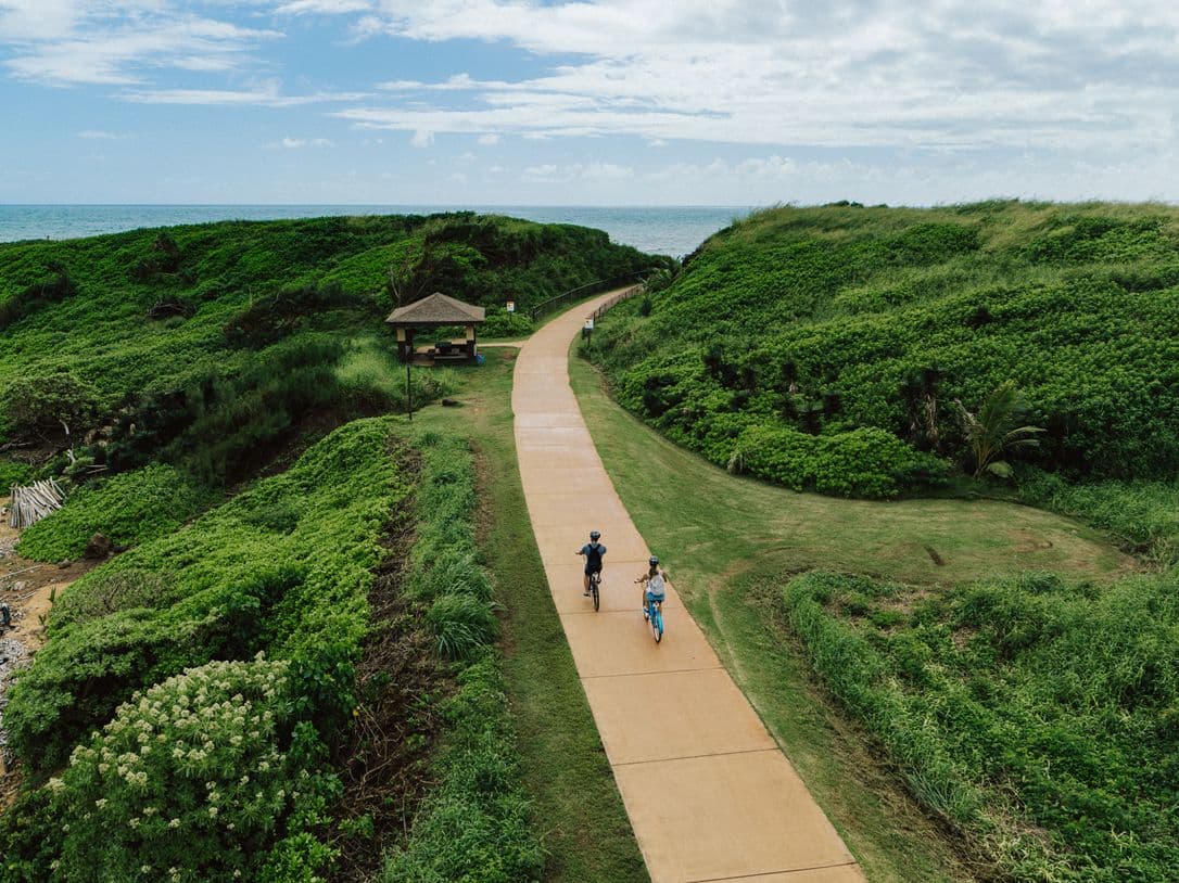 bike path amongst a green forest in kauai