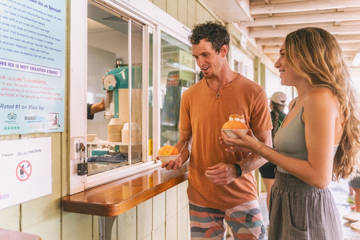 A couple getting shave ice at Ululani's Hawaiian Shave Ice in Kihei, Maui.