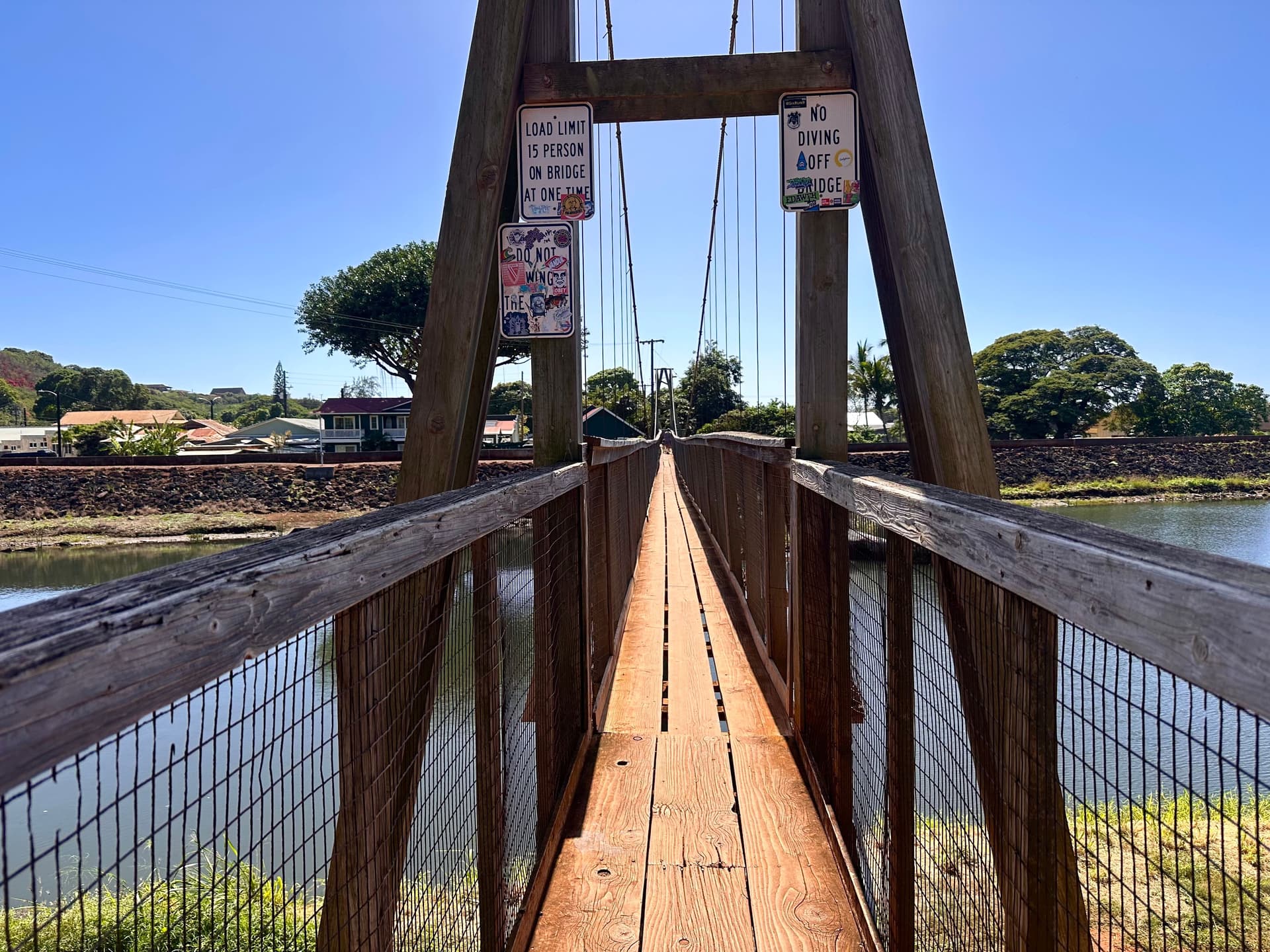A view of the hanapepe swinging bridge over the lake