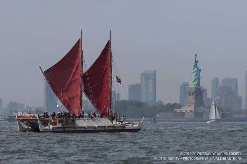 voyaging canoe and statue of liberty