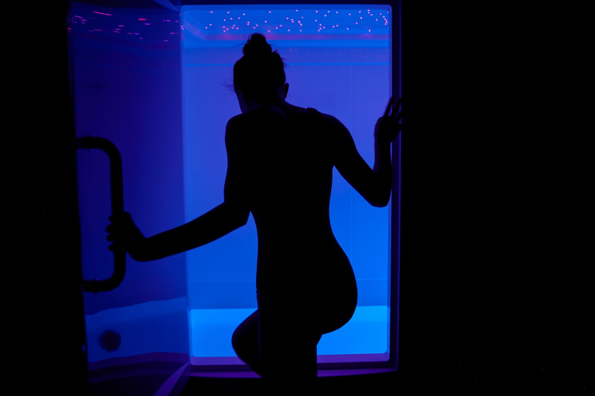 Woman coming out of a float tank.
