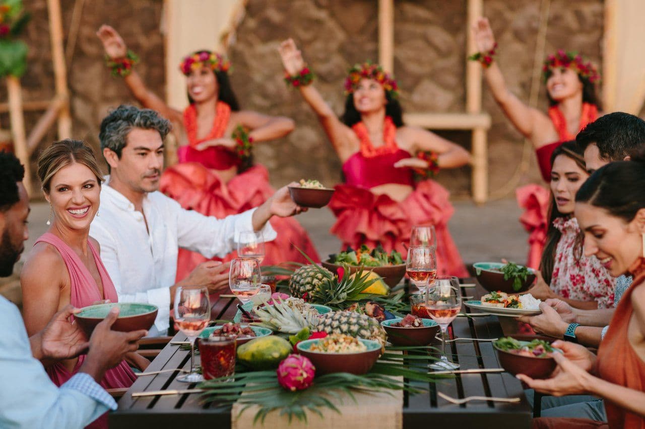 People at a luau eating dinner