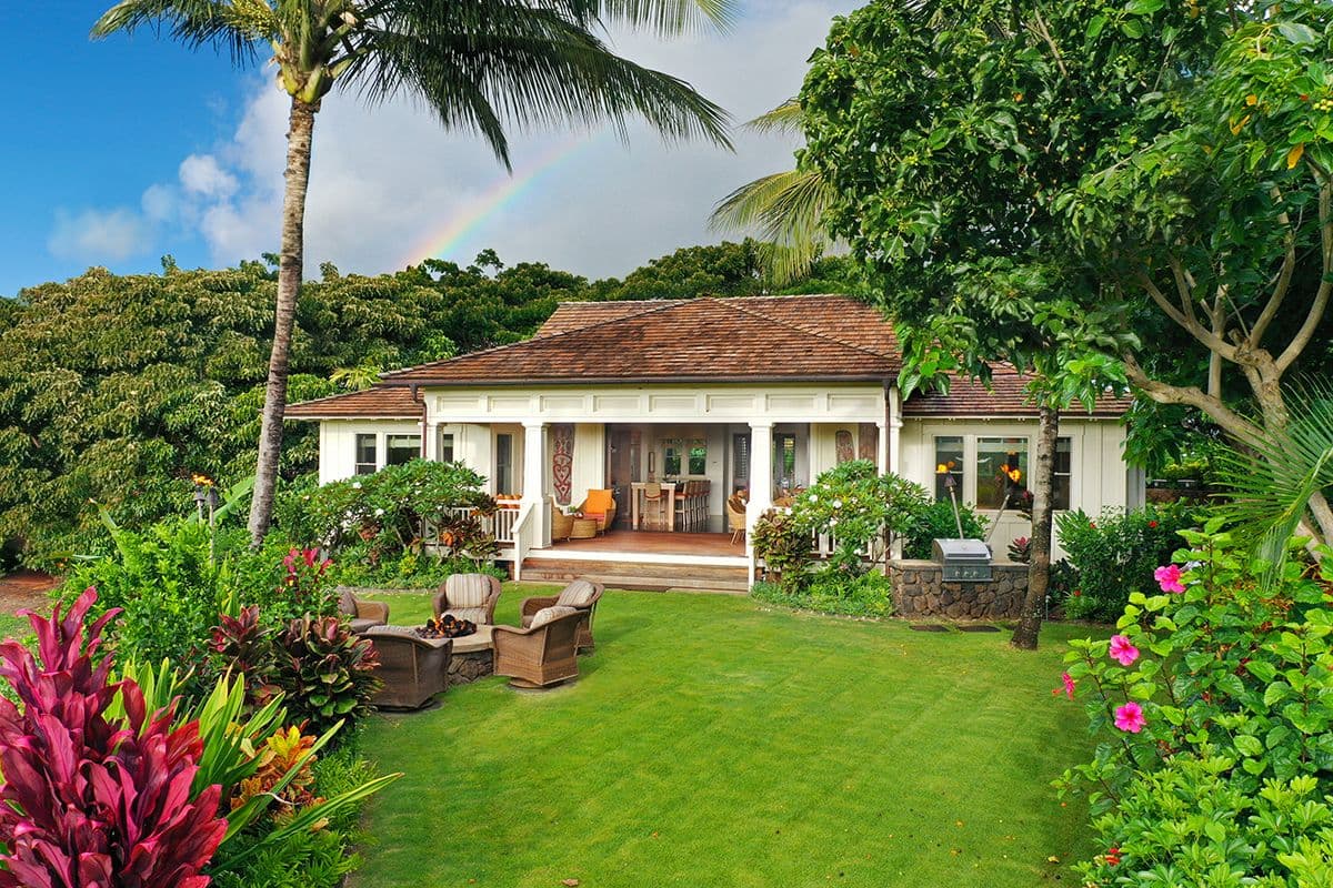 A white bungalow property in tropical landscaping in Hawaiil