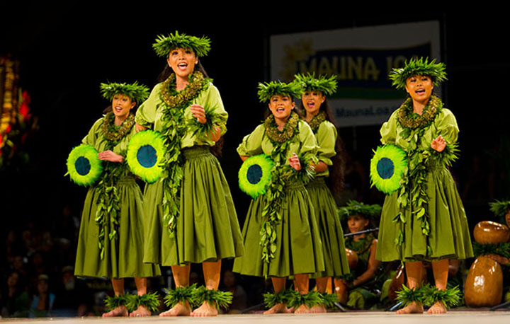 The wahine from Halau Hula 'O Kahikilaulani (Kumu Hula Nahokuokalani Gaspang; Hilo, HI) dance during the Kahiko portion of the Merrie Monarch Festival competition.  Photo:  Dennis Oda.