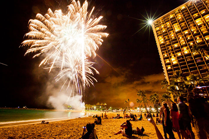 Image of Fireworks light up the night sky and bring revelers out to the beach to celebrate.