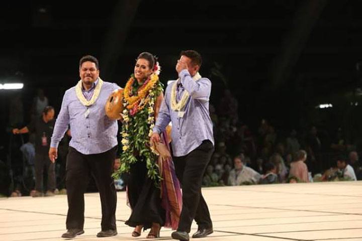 Miss Aloha Hula Kayli Ka'iulani Carr is flanked by her kumu, Lono Padilla, left, and Robert Ke'ano Ka'upu IV, after her win is announced Thursday night.