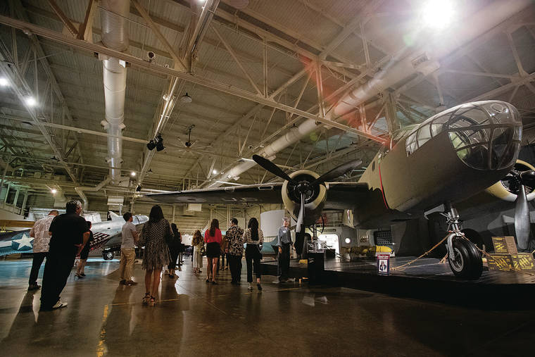 Visitors view large planes inside the Pacific Aviation Museum at Pearl Harbor. (Photo: Star-Advertiser)
