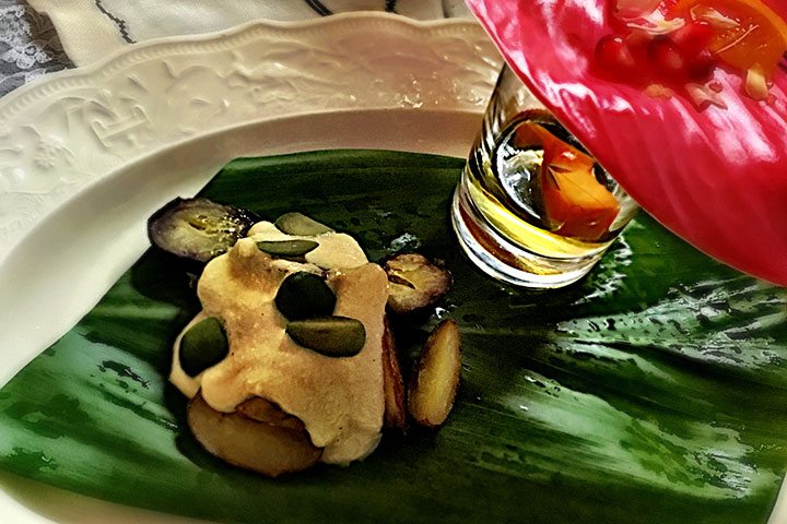 Image of Ocopa potatoes with pickled mango and cocoa leaf liqueur at the Frida Kahlo Art Dinner at Kona Hotel.