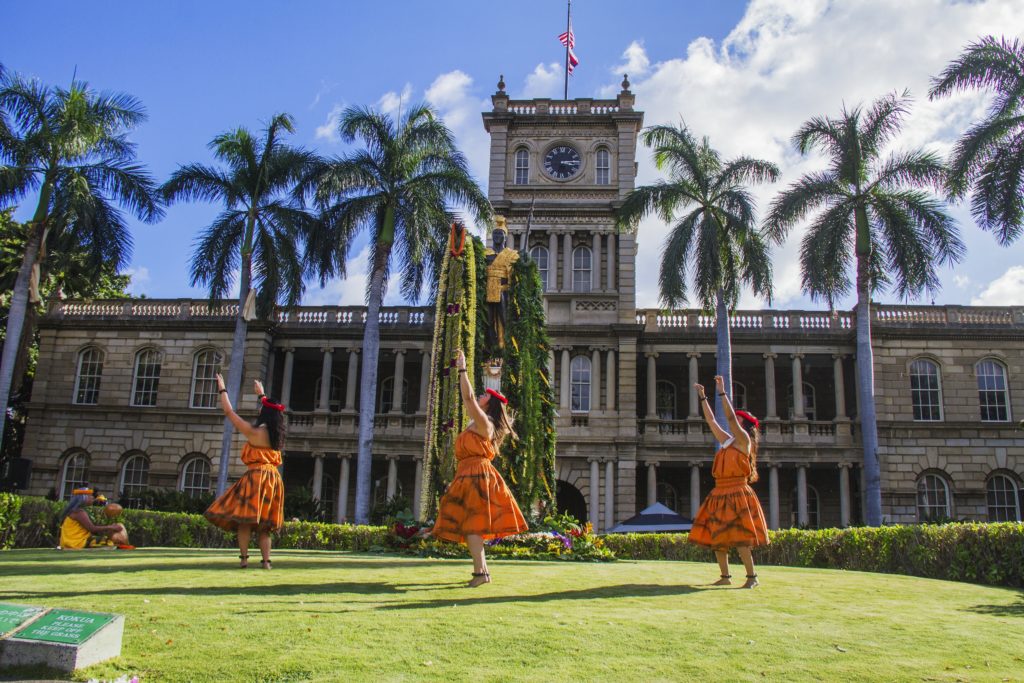 Hula dancers perform in front of the King Kamehameha statue in Honolulu