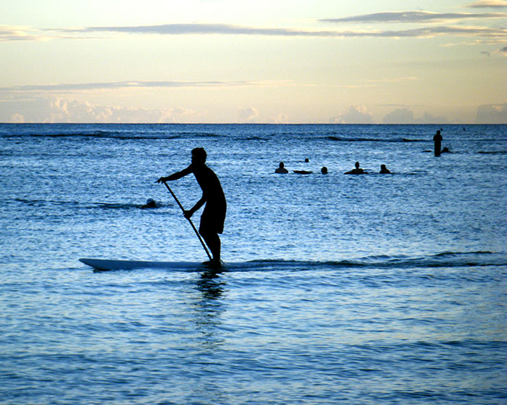 Image of paddleboarder at dusk